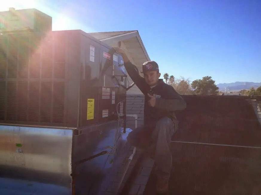 HVAC technician performing HVAC Inspection on a rooftop unit in Providence Village